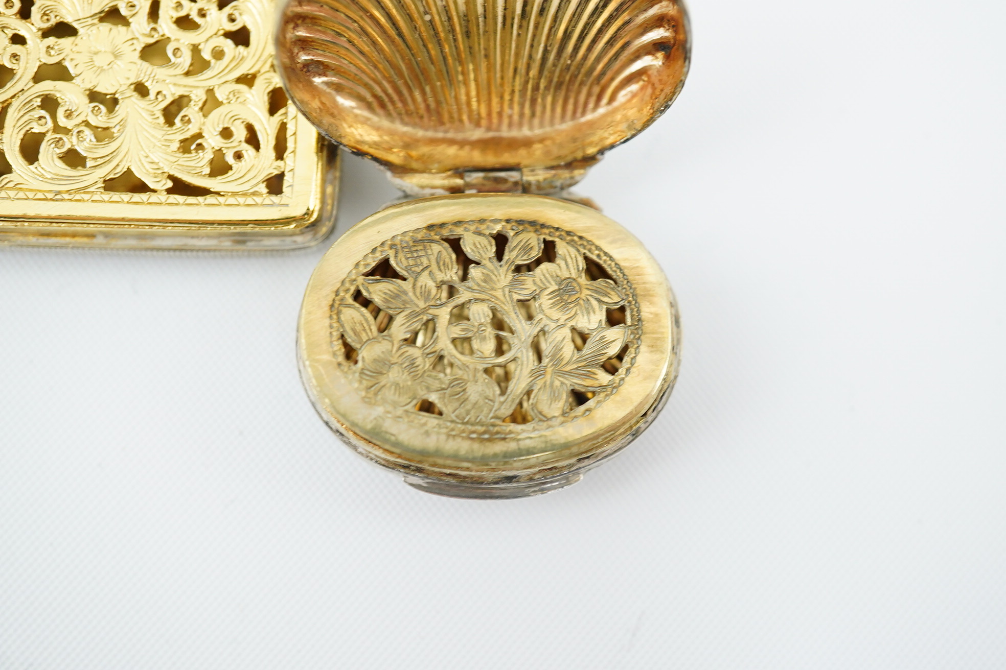 A late George III silver gilt vinaigrette by John Thropp, Birmingham, 1818, 30mm, together with a small shell shaped vinaigrette by Joseph Wilmore